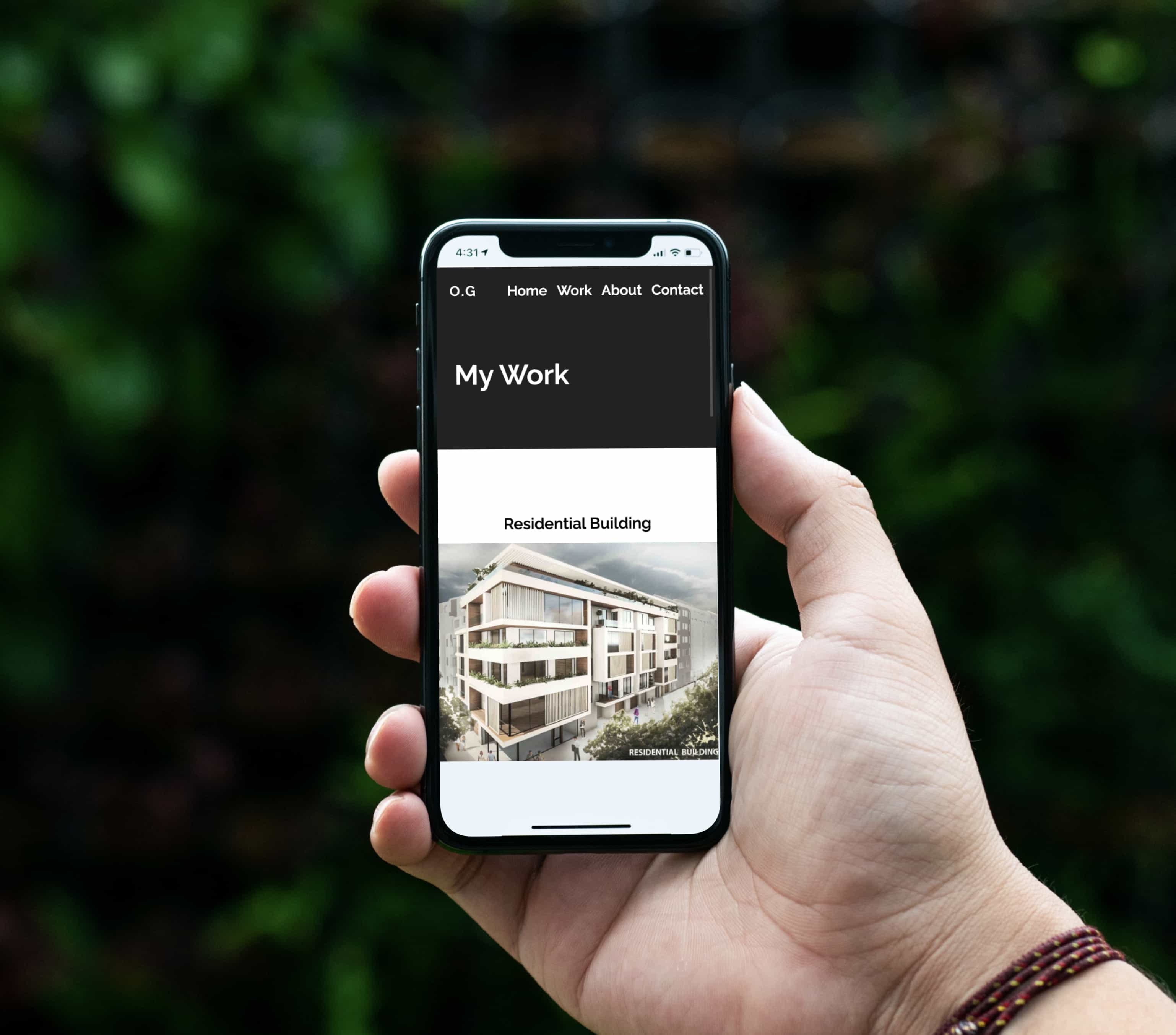 A hand holding up a mobile phone displaying one of the pages of our client's work on a faded green background.